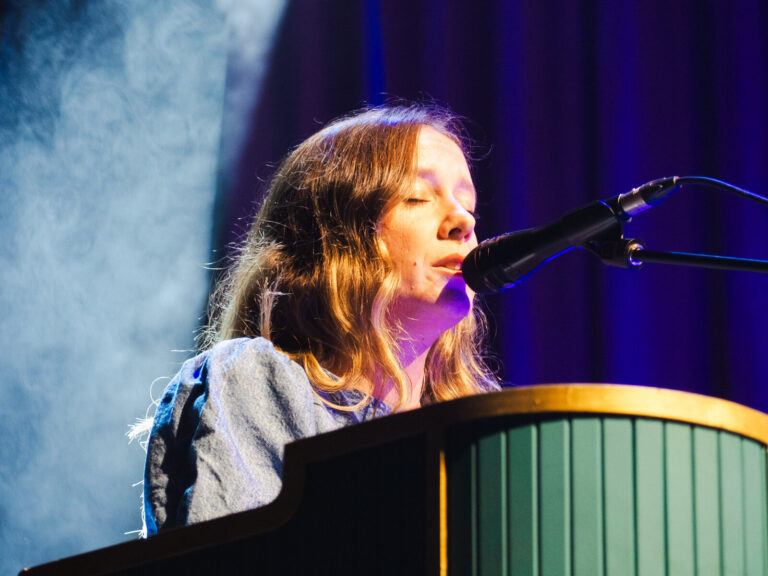 Primer plano de Nina de Juan cantando sentada al piano de cola en el concierto de Morgan en Sevilla